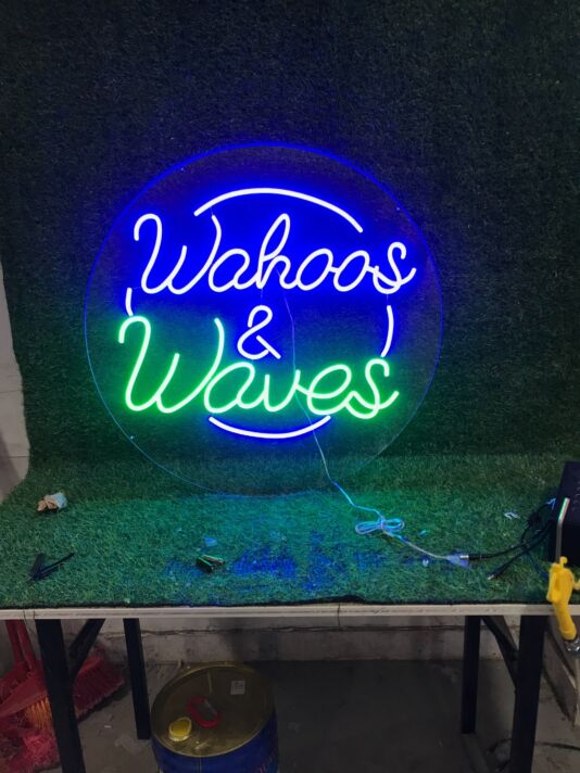 Brighten Up Your Bar, Surf Shop, or Beach House with the Wahoos And Waves Custom Logo LED Neon Sign.