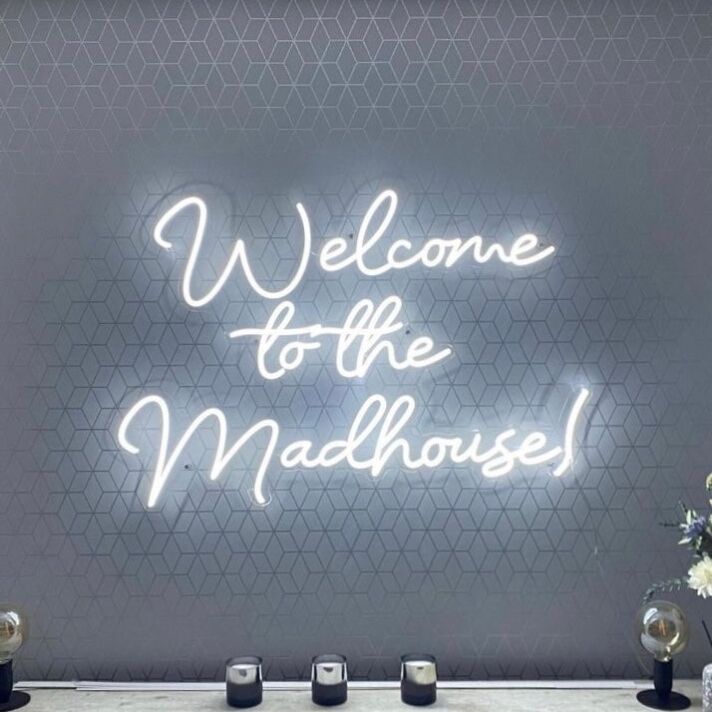 'Welcome To The Madhouse' Neon Sign