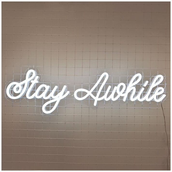 Stay Awhile Neon Sign perfect for cozy living room settings